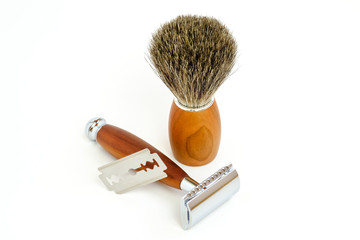 Traditional steel razor with hairy shaving brush isolated in white