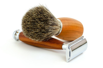 Traditional steel razor with hairy shaving brush isolated in white