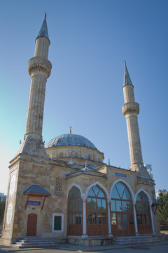 BAKU, AZERBAIJAN : The Mosque of the Martyrs Sehidler Mescidi Mosque, Turkish Mosque with the Flame Towers skyscraper in the background in Baku, Azerbaijan, at sunset.