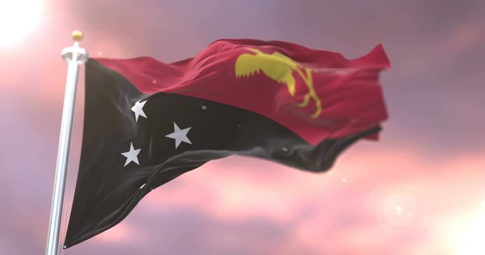 Flag of Papua New Guinea waving at wind at sunset in slow, loop