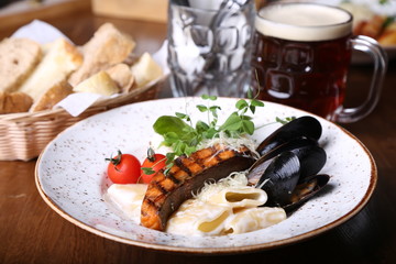 Tasty pasta with a salmon and mussels. Italian food