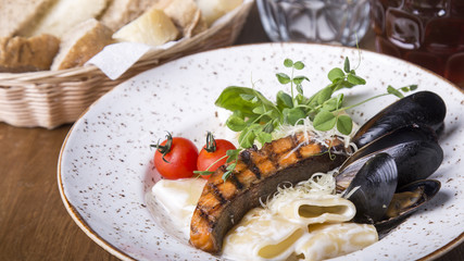 Italian pasta with a salmon and mussels