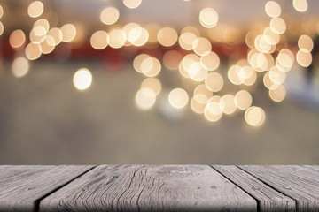 Old wooden table on front with blurred warm bokeh background, for persentation object