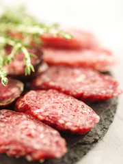 Sliced salami on cutting board