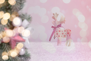 fir branch as a border with a blurred reindeer in the background