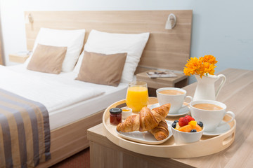 Hotel room serviced breakfast. In cozy hotel. - obrazy, fototapety, plakaty