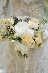 Beautiful wedding bouquet for the bride with peonies and white roses and eustoma
