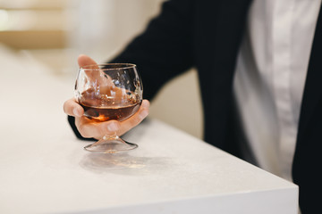 Grooms morning preparation. The details of the wedding day. The groom is holding a glass of whiskey