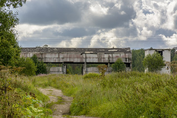 Fototapeta na wymiar Abandoned agricultural buildings near the village of Muya in the Leningrad region.