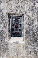 The Ordnance Survey Bench Mark on the side of a British triangulation point, or Trig Point