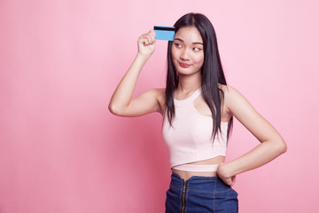 Young Asian woman think with a blank card.
