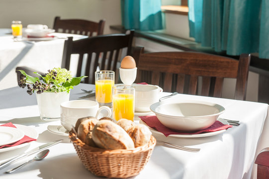Tables in restaurant ready for breakfast.