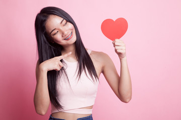 Asian woman point to red heart.