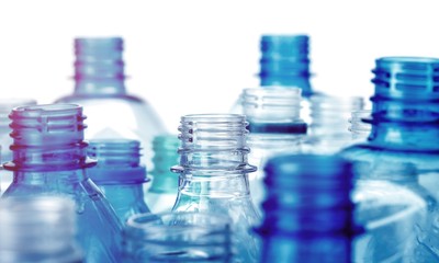Plastic bottles of water isolated on background