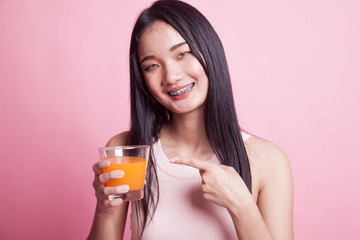 Young Asian woman point to orange juice.