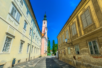 Obraz premium Ursuline church Varazdin town. / Scenic view at narrow baroque street in city center of Varazdin town, Croatia.