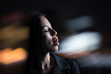 Unconventional mad woman showing sexy tongue at night city