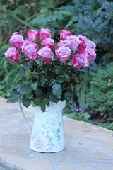 bouquet of fresh pink and white fresh roses in glass vase isolated on white background