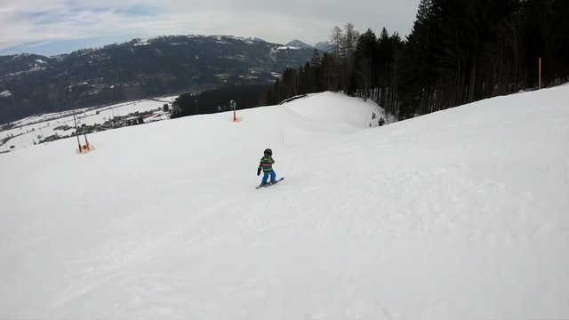Little boy skiing.
A 5 year old child enjoys a winter holiday in the Alpine resort. Stabilized footage. Slow motion.
