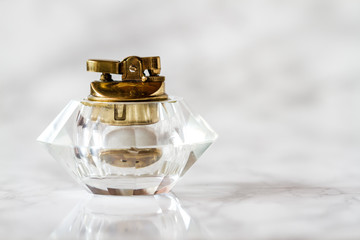 Vintage Glass Table Lighter on White Marble Background