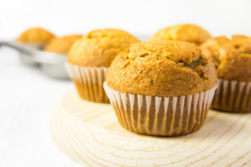 Freshly Baked Homemade Whole Wheat Bran Carrot Muffin on Wooden Board. Breakfast Morning Sunlight. Healthy Pastry Baking Concept. Minimalist Style Copy Space