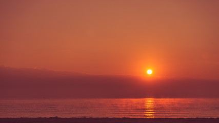 Sunrise or sunset over sea surface