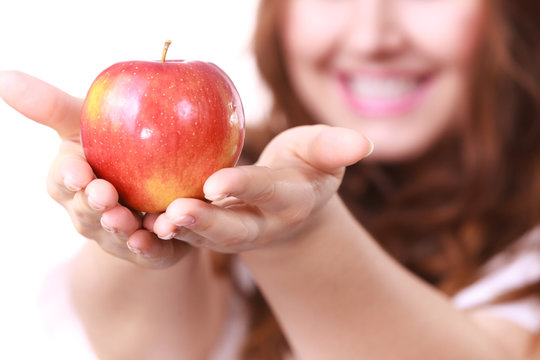 Woman holds red apple, focus on fruit