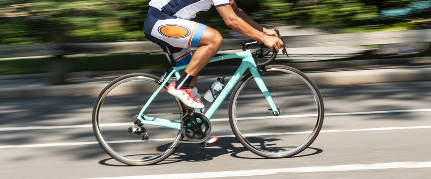 Cyclist racing uphill in Central Park blurred background