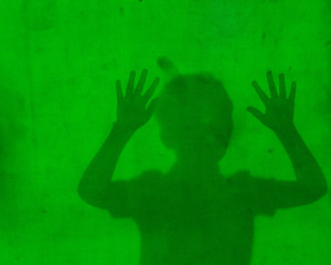 shadow of a scared child looking for help