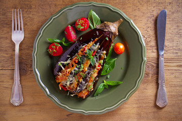 Baked eggplant, stuffed with meat, tomatoes, paprika, onion and cheese. Aubergine with meat and vegetables