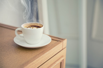 A cup of warm coffee on a table