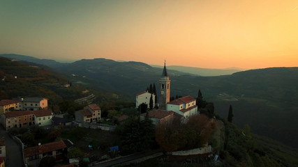 Fototapeta na wymiar Aerial view of a typical small village in the Italian hills at sunset.