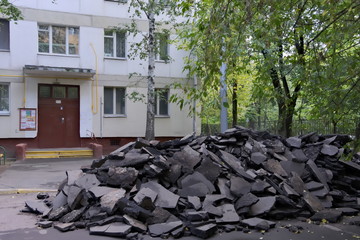 Broken asphalt pile at the front door of the 5-store building in Moscow