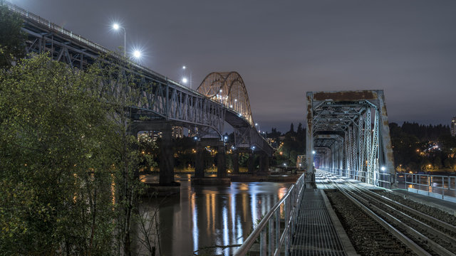 Patullo Bridge, Surrey, British Columbia, Canada. Long exposure of the bridge over the water. Sky Train Bridge.