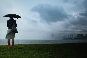 Large Storm With Woman Holding An Umbrella