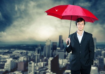 Portrait of  businessman with umbrella on background