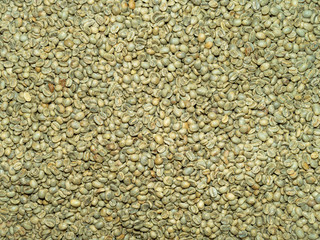 Top down close-up of Organic Green Coffee beans in storage.