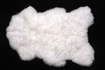 Beautiful white sheepskin isolated on a black background