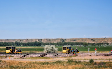 Fototapeta premium Railroad repair equipment on a railway in a Montana countryside landscape