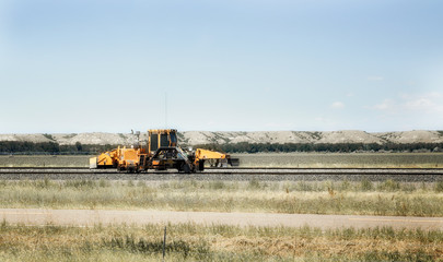 Fototapeta na wymiar Railroad repair equipment on a railway in a Montana countryside landscape