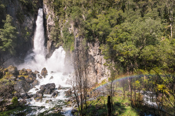 Fototapeta premium Tarawera falls with rainbow gushing out of fissures in the cliff, Rotorua, New Zealand