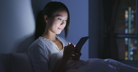 Woman use of mobile phone at night © leungchopan
