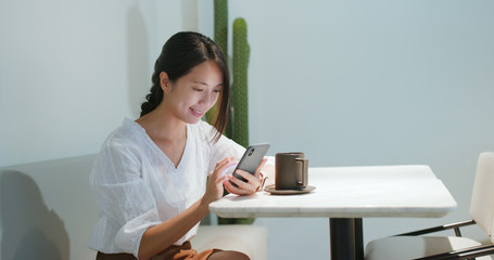 Woman use of smart phone in cafe