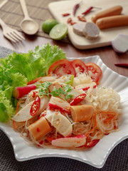 Thai yum salad hot and spicy with Vietnamese sausage, krab sticks, vermicelli and vegetables. Yum salad is a Thai local food, Spicy sour and sweet taste. © poravute