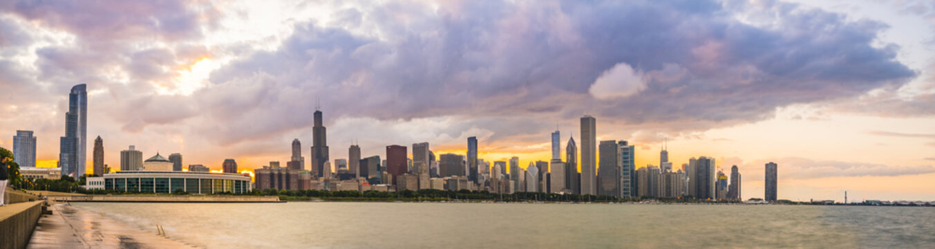 chicago,illinois,usa. 8-11-17: Chicago skyline at sunset with cloudy sky and reflection in water.
