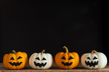 White and yellow ghost pumpkin on black background. halloween concept.