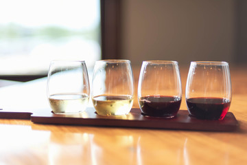 Tasting a variety of wines from a flight at a local vineyard - wine tasting event