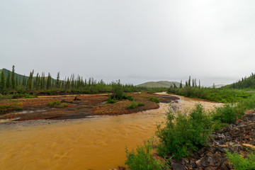 The Red Creek Runs Along The Dempster Highway, Yukon, Canada.