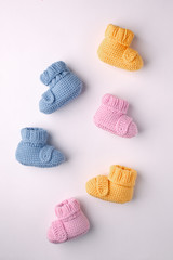 pregnancy concept, Three pairs of baby booties on a light background, flat lay, pattern