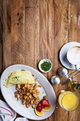 Breakfast table with omelette, coffee and orange juice